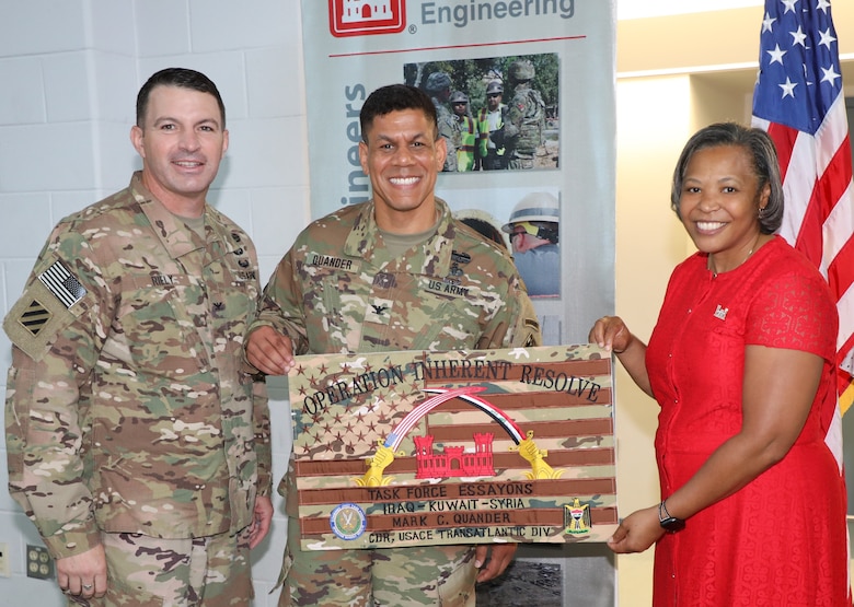 Task Force Essayons Commander Col. James Riely (left) presents a going away gift to outgoing Transatlantic Division Commander Col. Mark Quander and his wife Melanie. Quander relinquished command of TAD to incoming commander Col. Christopher Beck during a change of command ceremony held June 26, 2019, in Winchester, Va. The Quanders are heading to their next assignment at Fort Leonard Wood, Missouri.