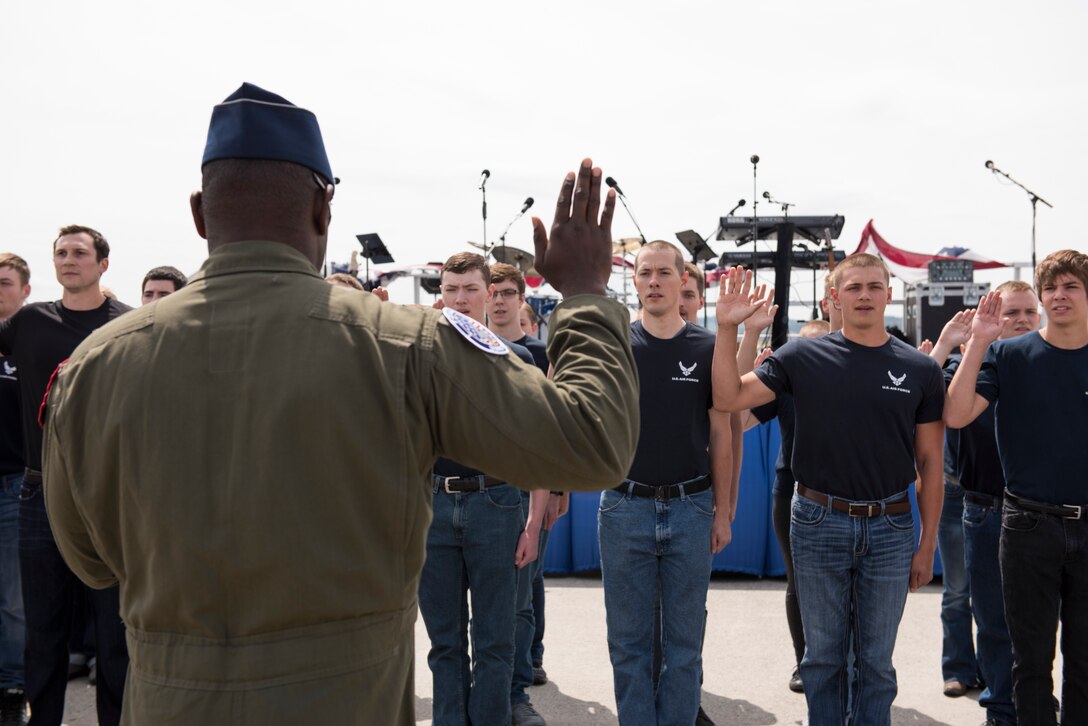 U.S. Air Force Maj. Paul "Loco" Lopez, F-22 Raptor Demo Team Pilot, speaks to the crowd before swearing in the Air Force’s latest recruits at the 2019 Skyfest Open House and Air Show opening ceremony at Fairchild Air Force Base, Washington, June 22, 2019. Fairchild opened its gates to the public for a free one-day event to showcase Pacific Northwest airpower and U.S. Air Force capabilities. The airshow included the F-22 Demonstration Team, U.S. Army Golden Knights and 11 other aerial acts. (U.S. Air Force photo by Senior Airman Ryan Lackey)