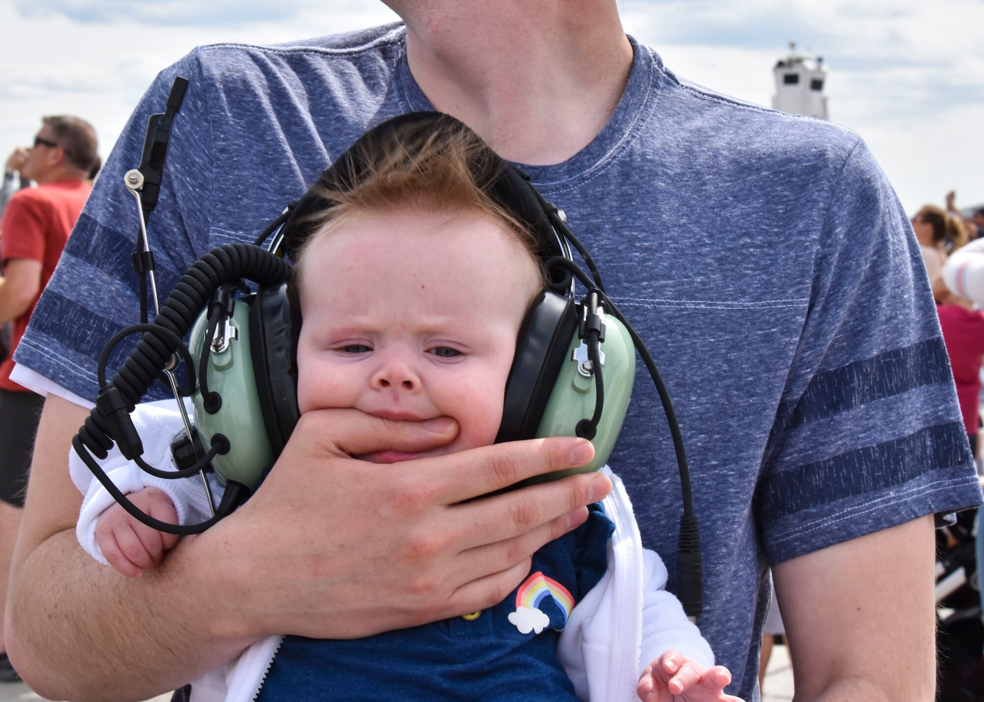 A baby chews on her father’s hand at the 2019 Skyfest Open House and Airshow on Fairchild Air Force Base, Washington, June 22, 2019. Skyfest 2019 gave the Inland Northwest a chance to meet members of Team Fairchild and see the U.S. Air Force’s premier air refueling wing in action during a simulated KC-135 Stratotanker low-pass refuel of a C-17 Globemaster III. (U.S. Air Force photo by Airman Kiaundra Miller)