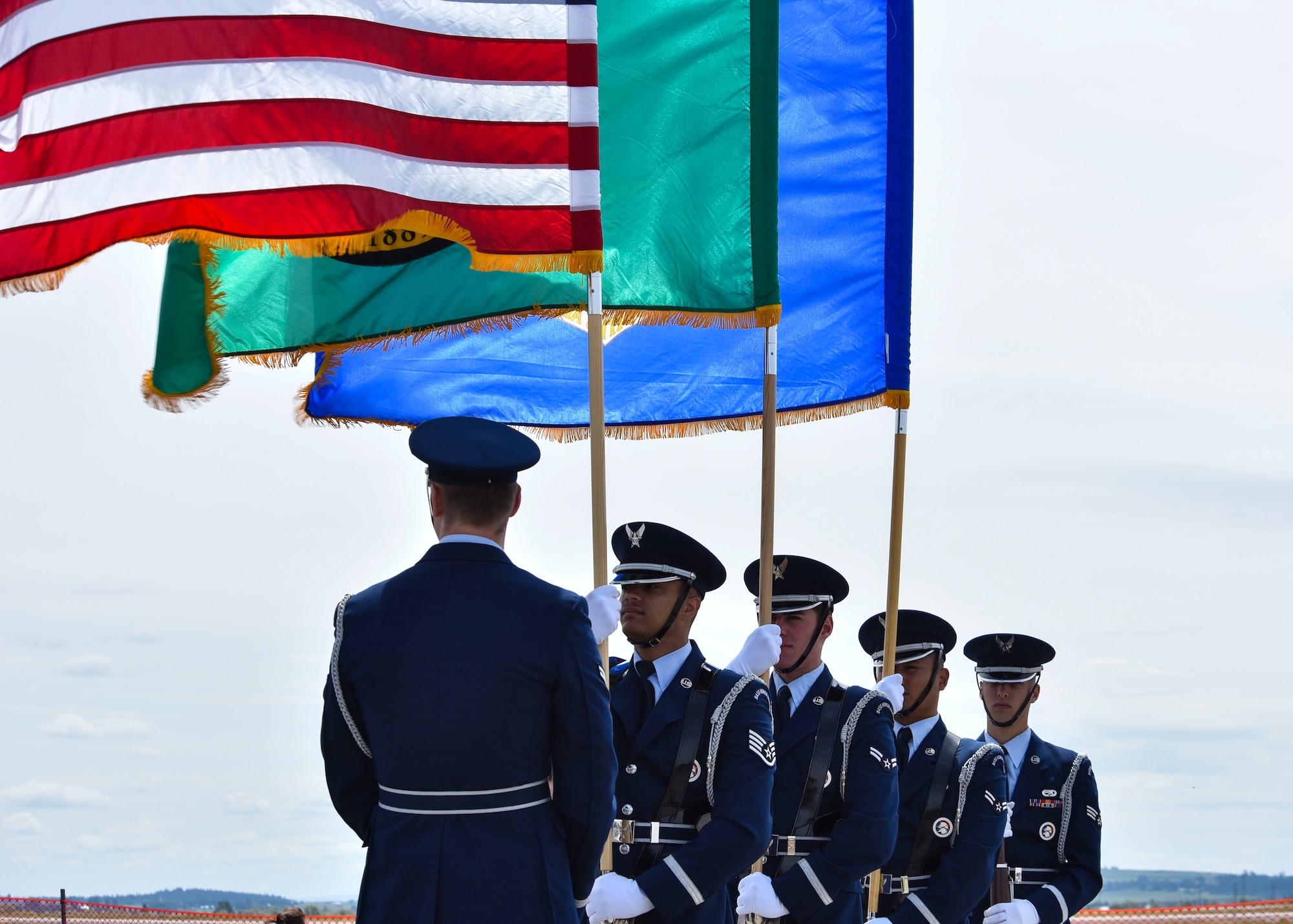 U.S. Air Force Honor Guard members wait to post colors during the 2019 Skyfest Open House and Airshow on Fairchild Air Force Base, Washington, June 22, 2019. Skyfest 2019 offered a unique view of Team Fairchild’s role in enabling Rapid Global Mobility for the U.S. Air Force. The show featured more than 13 aerial acts and 16 static display aircraft, as well as other attractions and displays. (U.S. Air Force photo by Airman Kiaundra Miller)