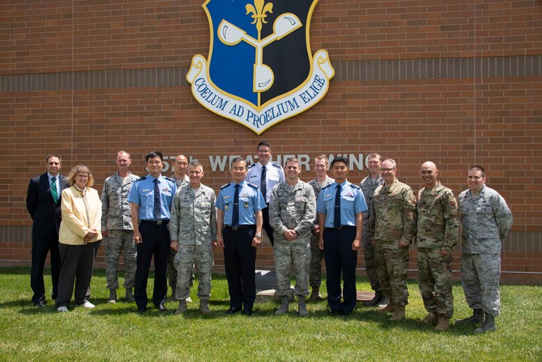 Members of the 557th Weather Wing and Republic of Korea Air Force Weather Wing pose for a group photo in front of the 557th WW headquarters building at Offutt Air Force Base, Nebraska, June 20, 2019. The biennial meeting between the 557th WW and ROKAF allows for a synchronization of priorities and lays the groundwork for future cooperation. (U.S. Air Force photo by Paul Shirk)