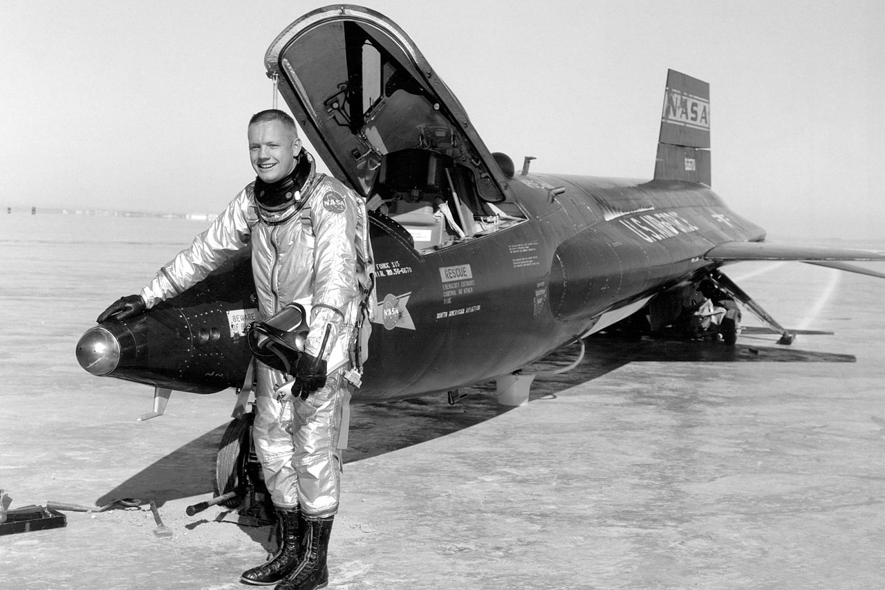 A man stands beside a jet.