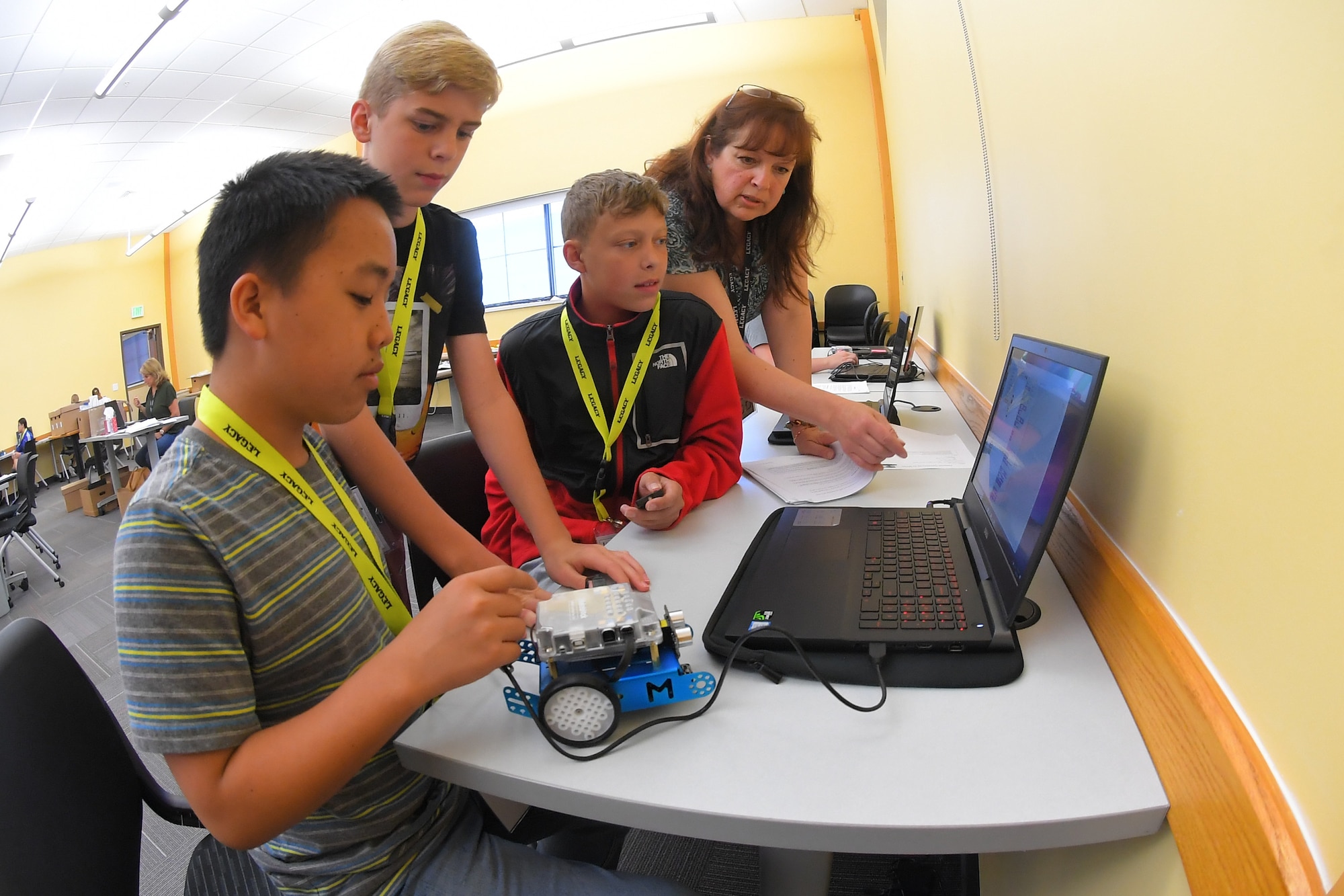 Students write code to program robots with instruction from instructor Patricia Bodley during a LEGACY (Leadership Experience Growing Apprenticeships Committed to Youth) program camp June 26, 2019, at the Freeport Center in Clearfield, Utah. LEGACY is an Air Force program aimed at building interest in science, technology, engineering and math (STEM) through hands-on activities while showing how STEM applies to the world. (U.S. Air Force photo by Todd Cromar)