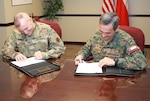 U.S. Army South hosted bilateral staff talks with Chilean army leaders June 24-28 at Joint Base San Antonio-Fort Sam Houston. Col. Darrin Bowser (left), Army South deputy chief of staff for logistics and the U.S. head of delegation for the staff talks, and Chilean army Col. Luis Cortes, the Chilean head of delegation sign an agreed-to-actions agreement between the two armies.