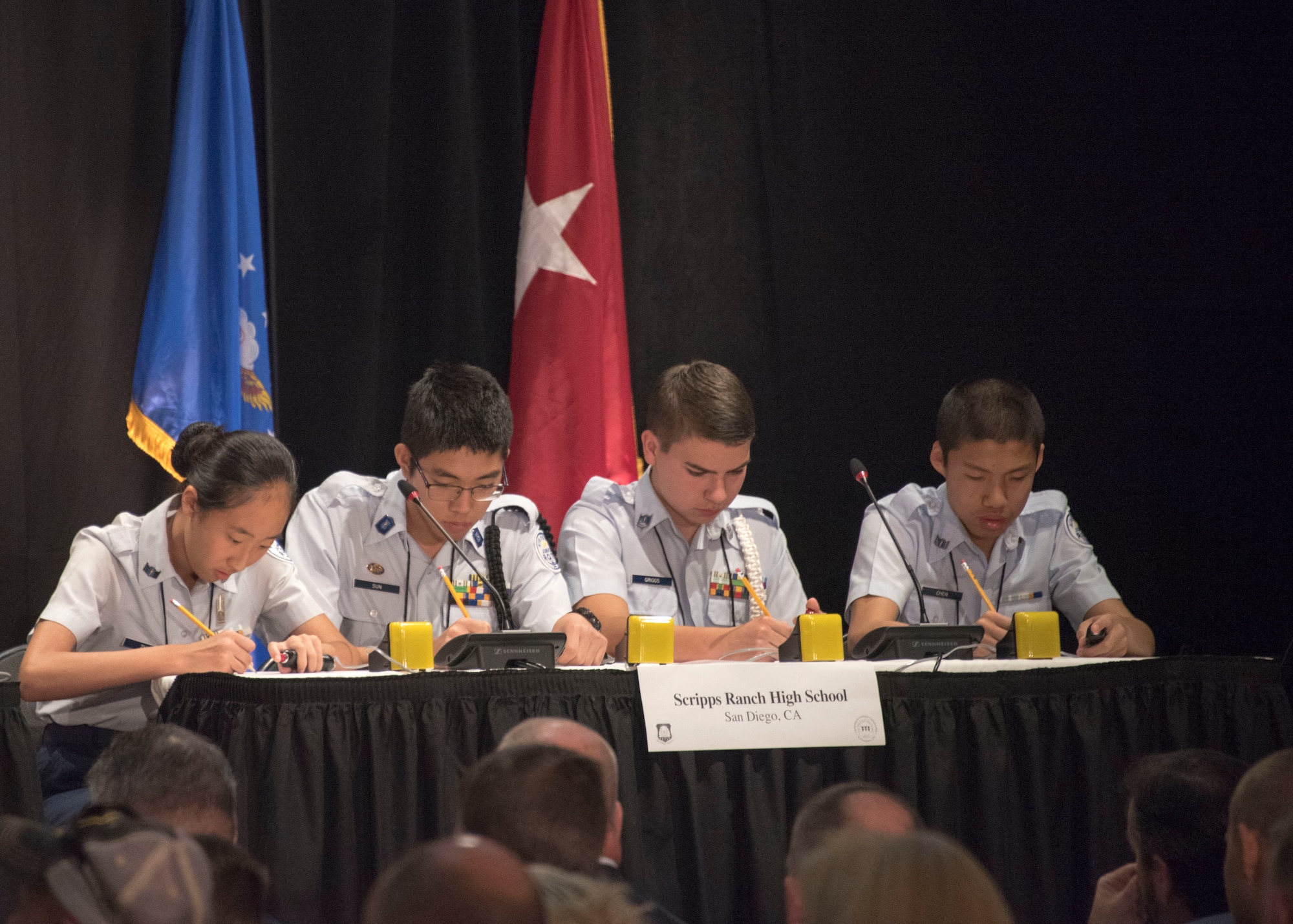 Air Force Junior Reserve Officer Training Corps team from Scripps Ranch High School, San Diego Calif., use pencil and paper to answer a math question during the finals of the  a question in which requited pencil and paper during the 8th Annual Joint Service Academic Bowl, in Washington, D.C., June 23, 2019. The team competed against more than 430 Air Force JROTC teams to make it to the finals after months of testing and competing. (Air Force Photo by Staff Sgt. Jared Duhon)