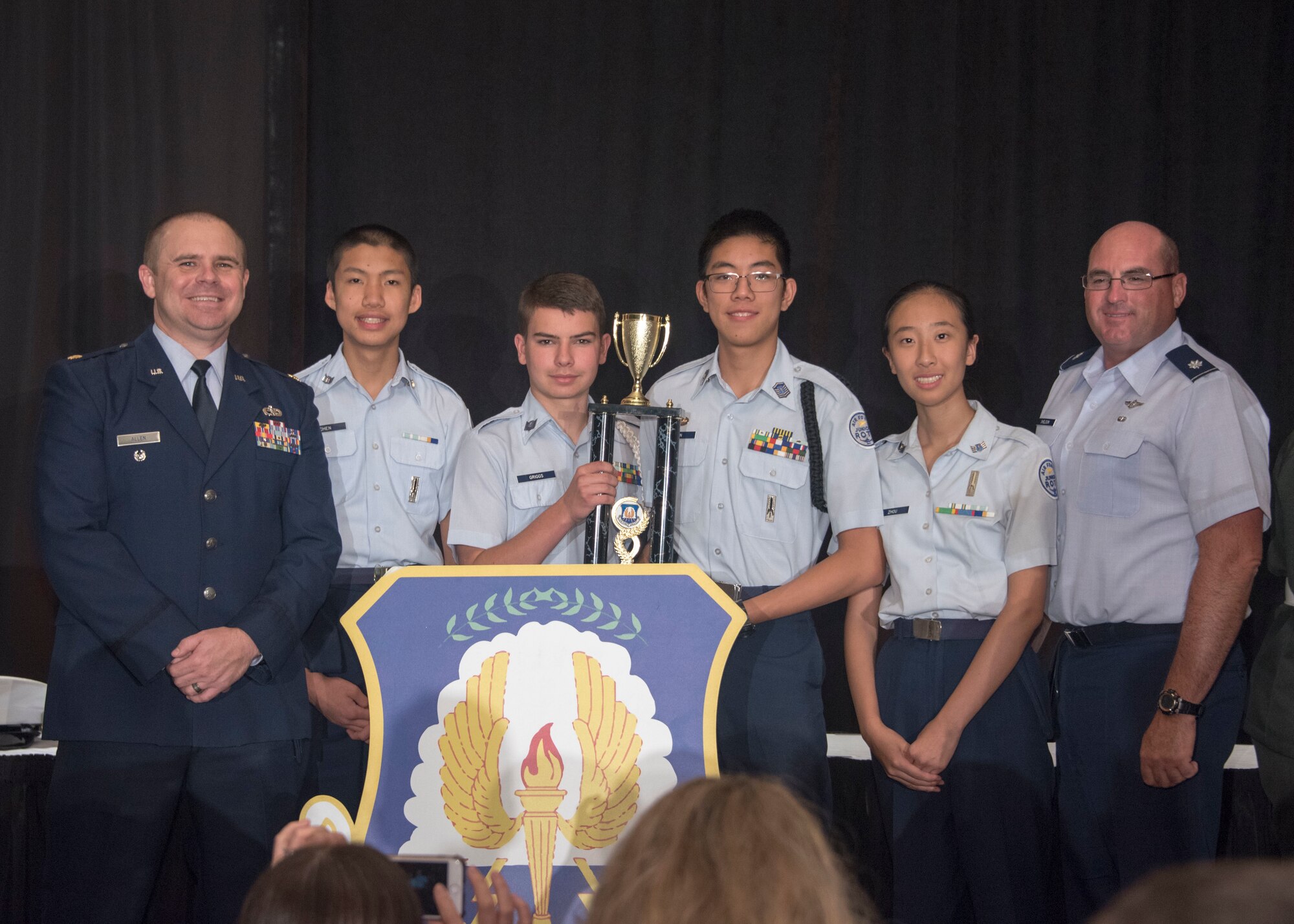 Cadets Samuel Chen, Kevin Griggs, Raymond Sun and Vanessa Zhou from Scripps Ranch High School, San Diego, Calif., celebrate second place with Maj. Michael Allen (left), operations deputy of Air Force JROTC, and Lt. Col. Michael Sheldon (right), JROTC instructor at Scripps Ranch High School during the 8th Annual JROTC Leadership and Academic Bowl award ceremony, in Washington, D.C., June 24, 2019.The Junior ROTC Academic Bowl is a multi-level competition that high school Junior ROTC units from each service participate in throughout the school year. The competition includes a mix of Junior ROTC curriculum, English, Math and Science, all skills that contribute to the Air Force Junior ROTC core mission of developing citizens of character. (Air Force Photo by Staff Sgt. Jared Duhon)