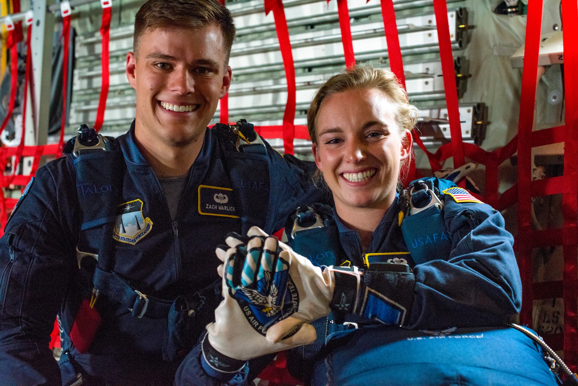 U.S. Air Force Academy cadets Zach Warlick and Sara Hill, U.S. Air Force Academy Wings of Blue parajumpers, pose for a photo in a C-130 Hercules ramp before leaping from 4,500 feet during the 2019 Skyfest Open House and Airshow at Fairchild Air Force Base, Washington, June 22, 2019. Fairchild opened its gates to the public for a free one-day event to showcase Pacific Northwest airpower and U.S. Air Force capabilities. The airshow included the F-22 Demonstration Team, U.S. Army Golden Knights and 11 other aerial acts.
 (U.S. Air Force photo by Airman 1st Class Whitney Laine)