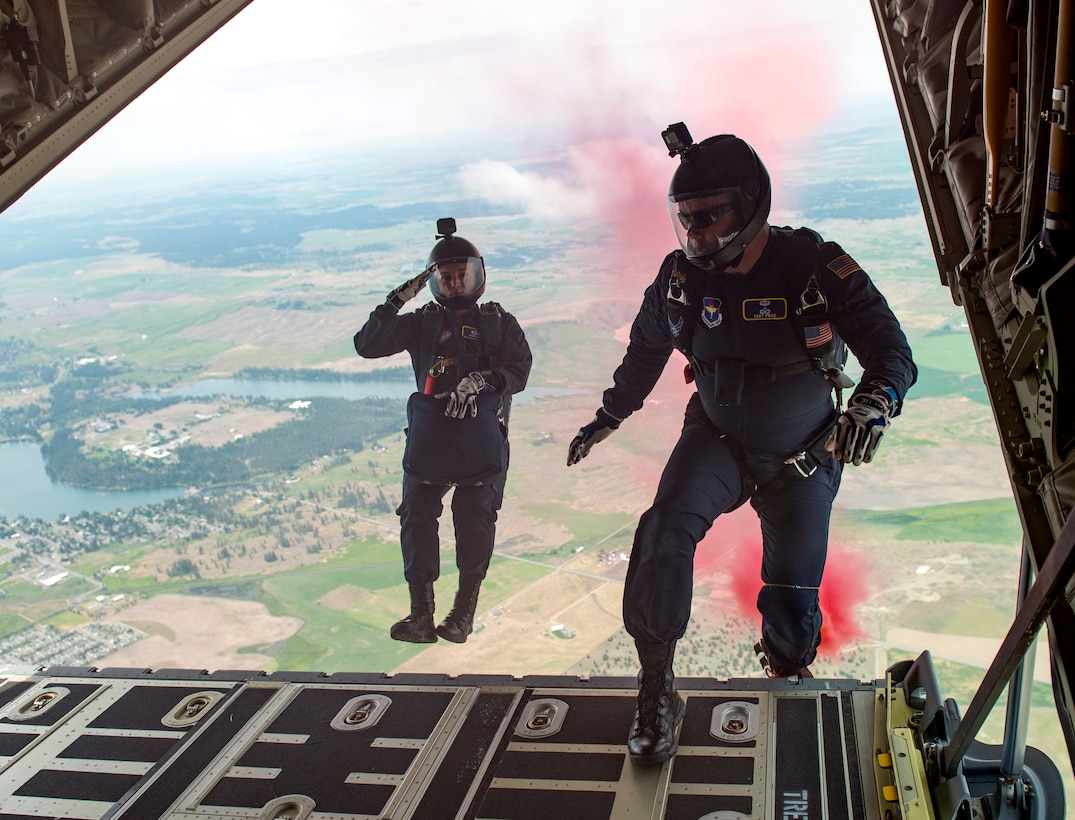 U.S. Air Force Academy cadet Sara Hill and Staff Sgt. Billy Price, Wings of Blue parajumpers, back off of the C-130 Hercules ramp from 4,500 feet during the 2019 Skyfest Open House and Airshow performance at Fairchild Air Force Base, Washington, June 22, 2019. Fairchild opened its gates to the public for a free one-day event to showcase Pacific Northwest airpower and U.S. Air Force capabilities. The airshow included the F-22 Demonstration Team, U.S. Army Golden Knights and 11 other aerial acts. (U.S. Air Force photo by Airman 1st Class Whitney Laine)