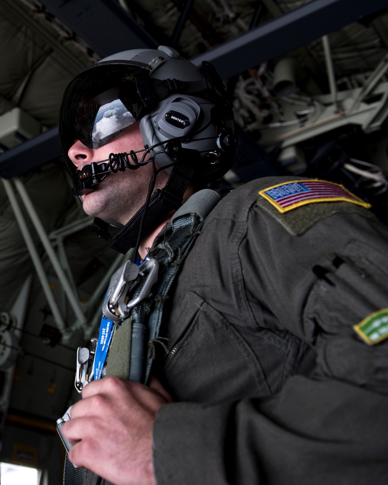 U.S. Air Force Airman 1st Class Nick Hooker, 61st Airlift Squadron loadmaster, waits for the wind to settle for the next U.S. Air Force Academy Wings of Blue parachute team to bound off of the C-130 Hercules’s ramp from 7,700 feet to the ground during the 2019 Skyfest Open House and Airshow performance at Fairchild Air Force Base, Washington, June 22, 2019. Fairchild opened its gates to the public for a free one-day event to showcase Pacific Northwest airpower and U.S. Air Force capabilities. The airshow included the F-22 Demonstration Team, U.S. Army Golden Knights and 11 other aerial acts. (U.S. Air Force photo by Airman 1st Class Whitney Laine)