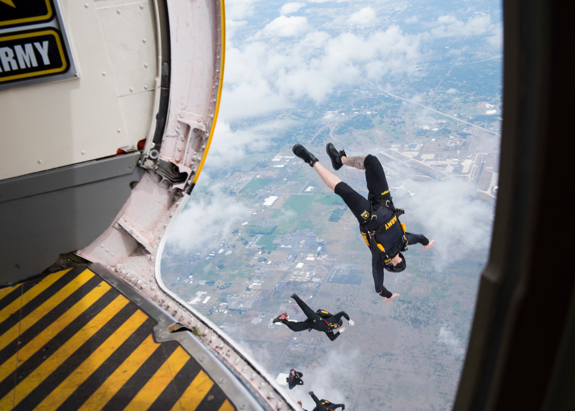 Members of the U.S. Army Golden Knights parachute team jumps as part of their performance during the Skyfest 2019 Open House and Airshow at Fairchild Air Force Base, Washington, June 22, 2019. Fairchild opened its gates to the public for a free one-day event to showcase Pacific Northwest airpower and U.S. Air Force capabilities. The airshow included the F-22 Demonstration Team, U.S. Army Golden Knights and 11 other aerial acts. (U.S. Air Force photo by Airman 1st Class Lawrence Sena)