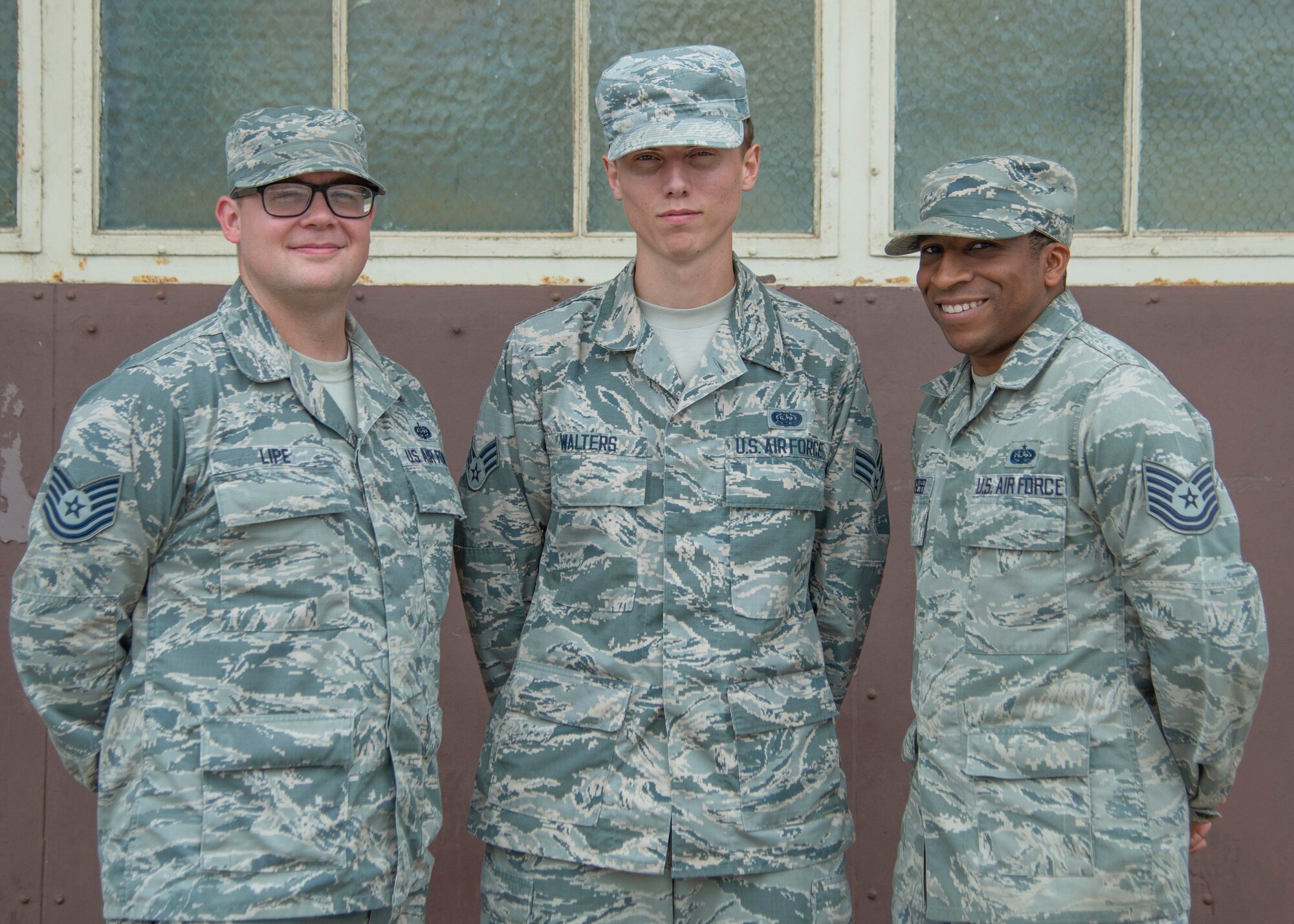 U.S. Air Force Tech. Sgt. Casey Lipe, 792nd Intelligence Support Squadron Mission Defense Team members NCO in charge, Senior Airman Gage Walters, 792nd ISS MDT member, and Tech. Sgt. Lavelle Burgess, 792nd ISS MDT NCOIC of mission defense programming, pose for a group photo at Joint Base Pearl Harbor-Hickam, Hawaii, June 26, 2019. The MDT created the Functional Research Innovation Systems for Brainstorming and Evaluation Environment, or FRISBEE Lab, as a virtual testing ground for their shop, which has become an integral training tool. (U.S. Air Force photo by Senior Airman Douglas Lorance)