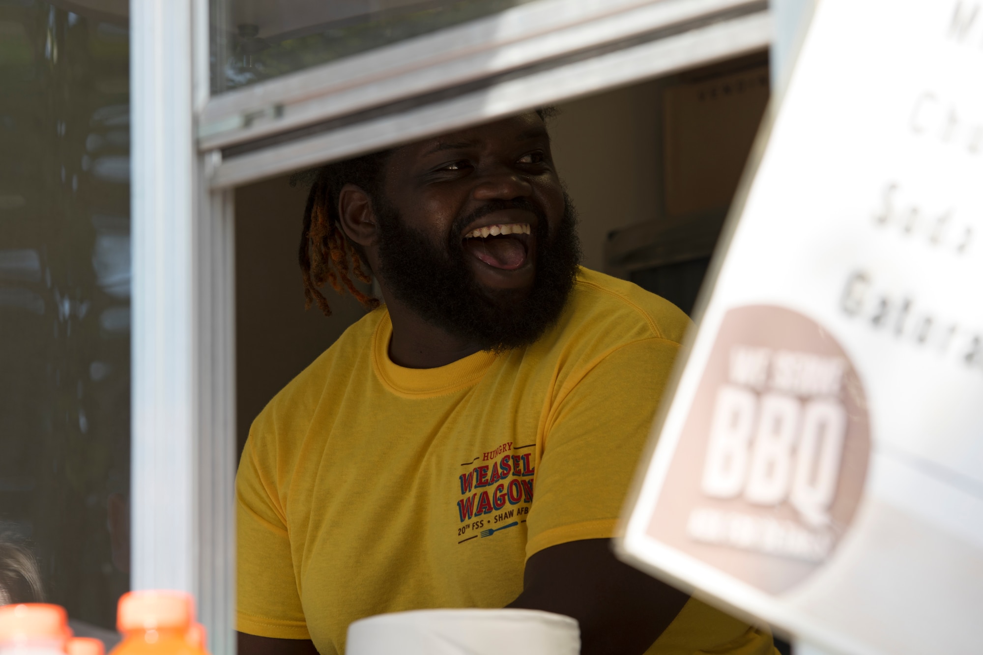 A 20th Force Support Squadron (FSS) food service employee laughs with a coworker in the Weasel Wagon during the 20th FSS Freedom Bash at Shaw Air Force Base, South Carolina, June 29, 2019.
