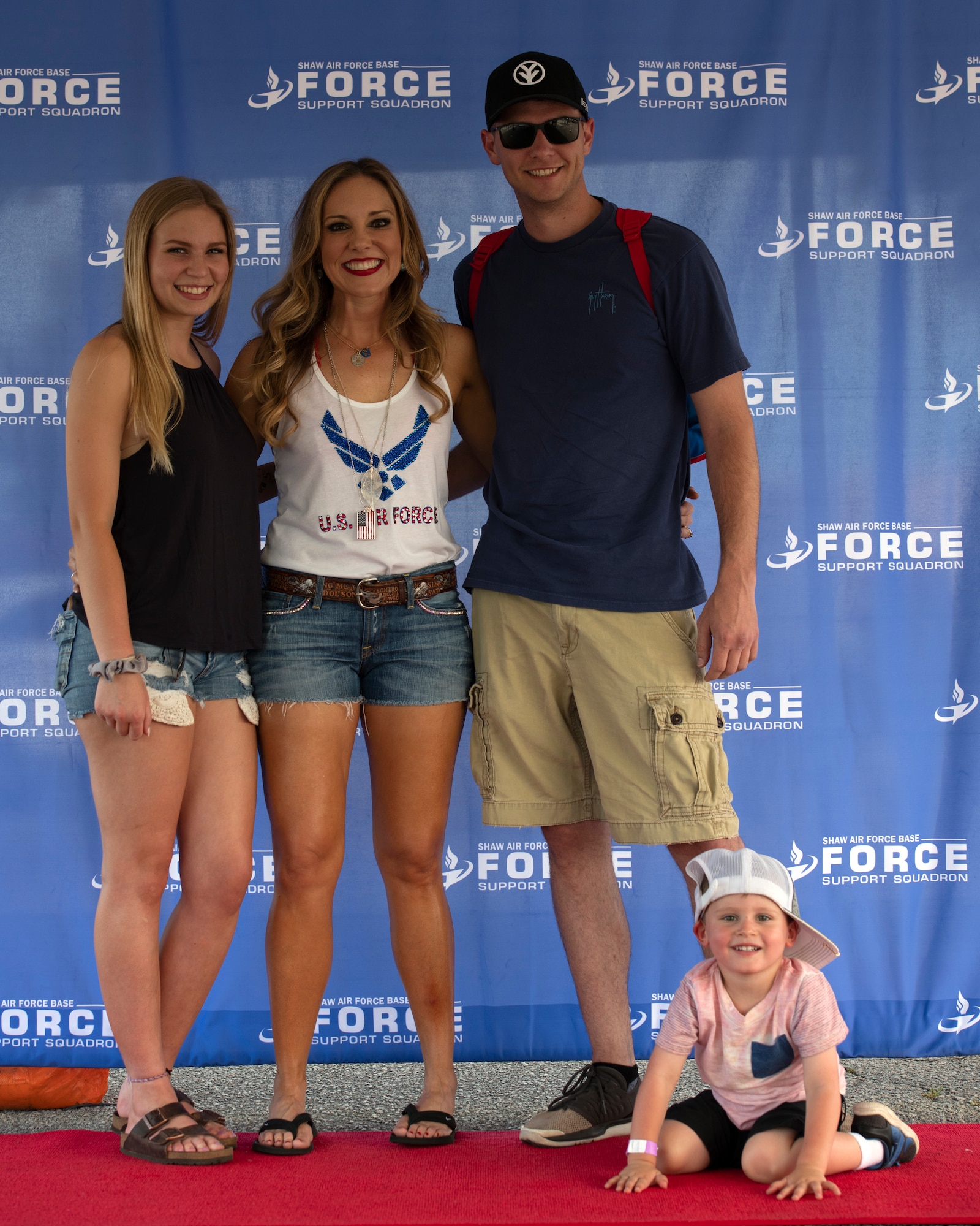 Leslie Tom, country music artist, center, stands with Team Shaw members during the 20th Force Support Squadron Freedom Bash at Shaw Air Force Base, South Carolina, June 29, 2019.
