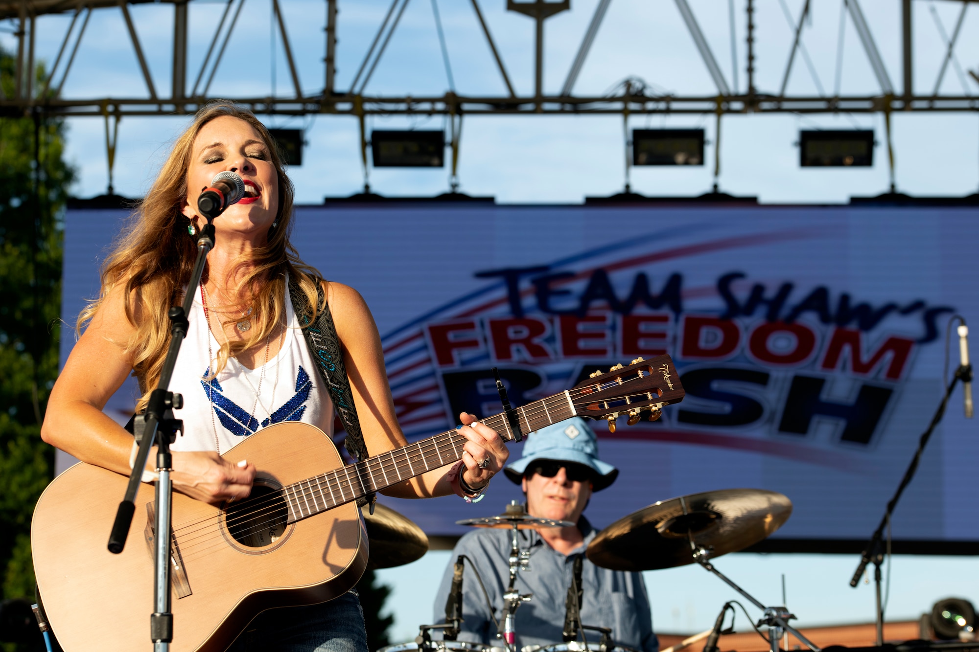 Leslie Tom, country music artist, sings on stage during the 20th Force Support Squadron Freedom Bash at Shaw Air Force Base, South Carolina, June 29, 2019.