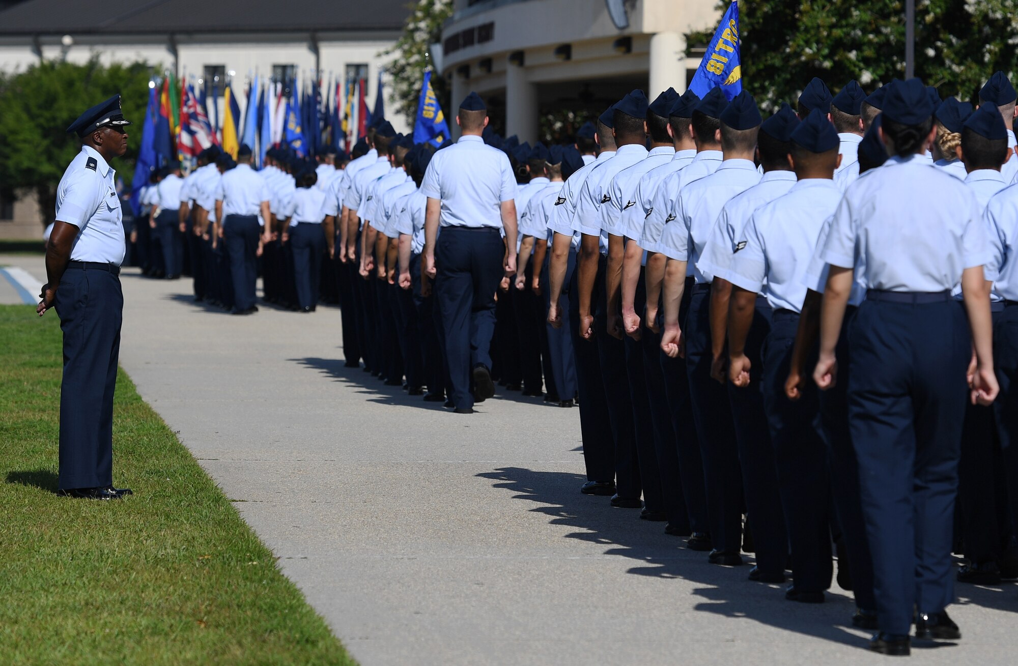 U.S. Air Force Lt. Col. Andre Johnson, 338th Training Squadron commander, stands at parade rest as Airmen from the 81st Training Group march for a pass and review during the 81st TRG change of command ceremony on the Levitow Training Support Facility drill pad at Keesler Air Force Base, Mississippi, July 1, 2019. U.S. Air Force Col. Chance Geray, incoming 81st TRG commander, assumed command from Col. Leo Lawson, Jr., outgoing 81st TRG commander. (U.S. Air Force photo by Kemberly Groue)