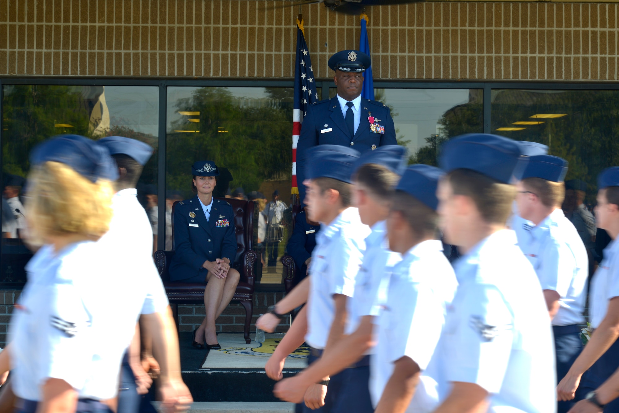 U.S. Air Force Col. Heather Blackwell, 81st Training Wing commander, and Col. Leo Lawson Jr., outgoing 81st Training Group commander, watch Airmen march in formation during the 81st TRG change of command ceremony at the Levitow Training Support Facility drill pad at Keesler Air Force Base, Mississippi, July 1, 2019. The ceremony is a symbol of command being exchanged from one commander to the next. Lawson passed command of the 81st TRG to Col. Chance Geray, incoming 81st TRG commander. (U.S. Air Force photo by Airman Seth Haddix)