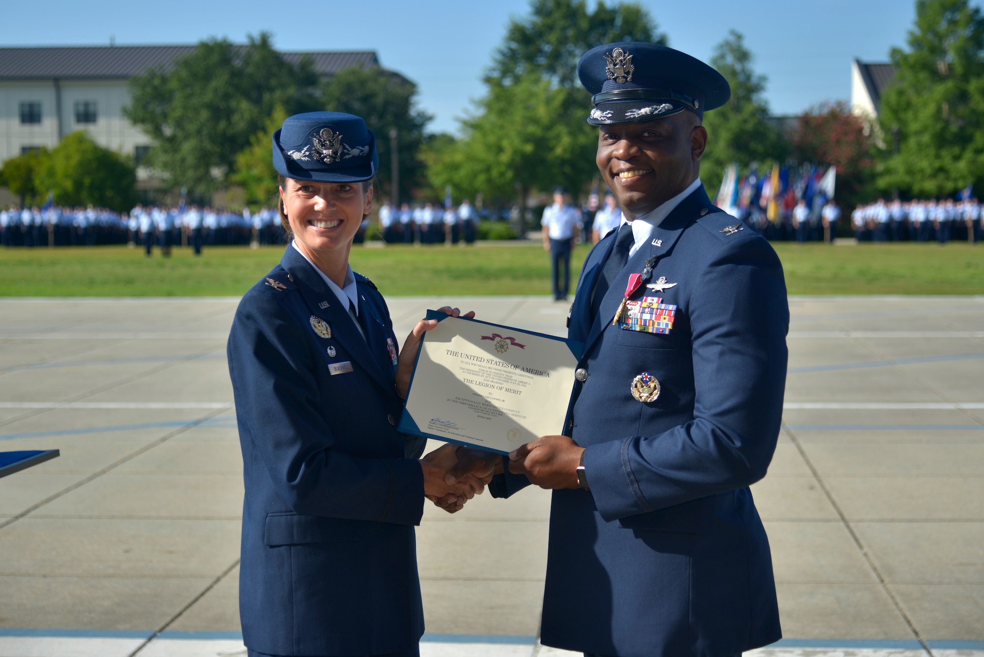 U.S. Air Force Col. Heather Blackwell, 81st Training Wing commander, presents the Legion of Merit award to Col. Leo Lawson Jr., outgoing 81st Training Group commander, during the 81st TRG change of command ceremony at the Levitow Training Support Facility drill pad at Keesler Air Force Base, Mississippi, July 1, 2019. Lawson's next assignment is to United States Transportation Command. (U.S. Air Force photo by Airman Seth Haddix)