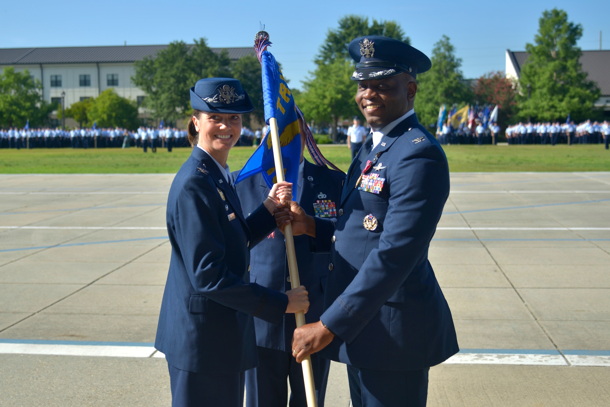 U.S. Air Force Col. Heather Blackwell, 81st Training Wing commander, takes the guidon from Col. Leo Lawson Jr., outgoing 81st Training Group commander, during the 81st TRG change of command ceremony at the Levitow Training Support Facility drill pad at Keesler Air Force Base, Mississippi, July 1, 2019. The ceremony is a symbol of command being exchanged from one commander to the next. Lawson passed on command of the 81st TRG to Col. Chance Geray, incoming 81st TRG commander. (U.S. Air Force photo by Airman Seth Haddix)