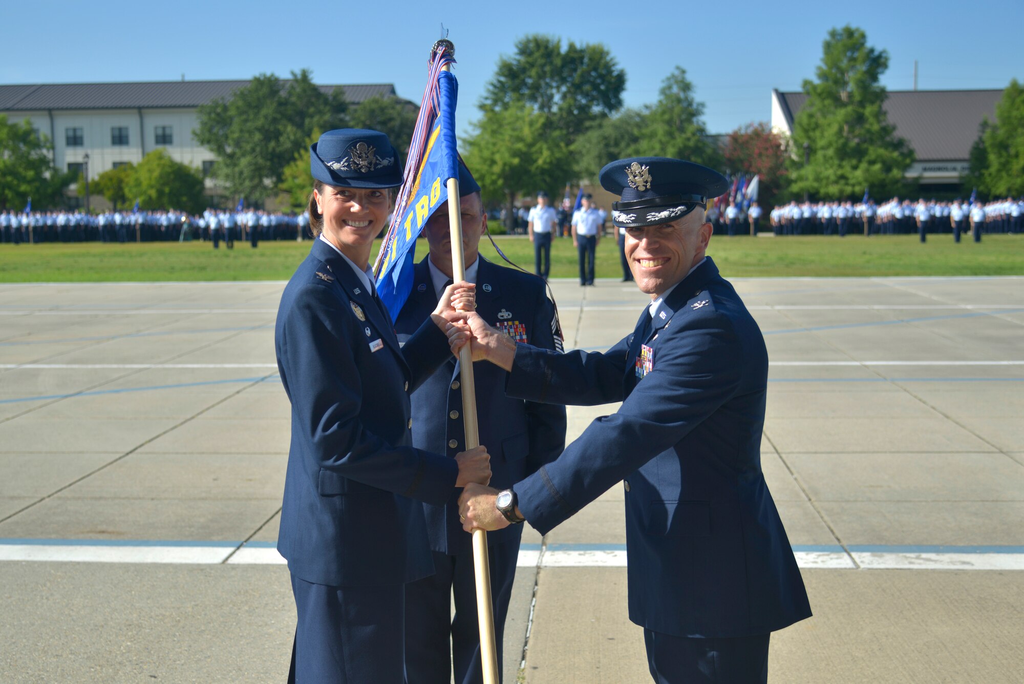 U.S. Air Force Col. Heather Blackwell, 81st Training Wing commander, passes the 81st Training Group guidon to Col. Chance Geray, 81st TRG commander, during the 81st TRG change of command ceremony at the Levitow Training Support Facility drill pad at Keesler Air Force Base, Mississippi, July 1, 2019. The passing of the guidon is a ceremonial symbol of exchanging command from one commander to another. Geray assumed command of the 81st Training Group from Col. Leo Lawson Jr., outgoing 81st TRG commander. (U.S. Air Force photo by Airman Seth Haddix)