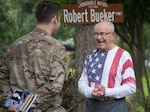 Robert C. Bueker, a local retiree and former World War II prisoner of war laughs with First Lt. Christian Eberhardt, 502d Air Base Wing Public Affairs Officer at his home July 3, 2019. Bueker celebrated his 95th birthday a day early with the help of Joint Base San Antonio presenting him with a personalized letter from Col. Mark Robinson, commander of the 12th Flying Training Wing, and a flag that has been flown onboard an F-16 during 2017 support operations in Afghanistan. (U.S. Air Force photo by: Airman 1st Class Shelby Pruitt)