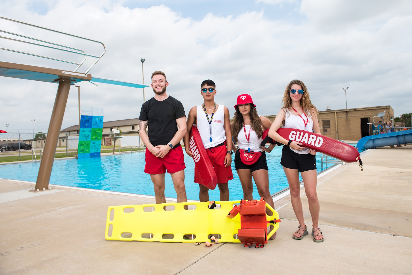 Bailey Parker, Eric Medelez, Silvia Garcia and Savannah Delange, 502nd Force Support Squadron lifeguards, pose for a photo at the Warhawk pool,June 21, 2019, at Joint Base San Antonio-Lackland, Texas.