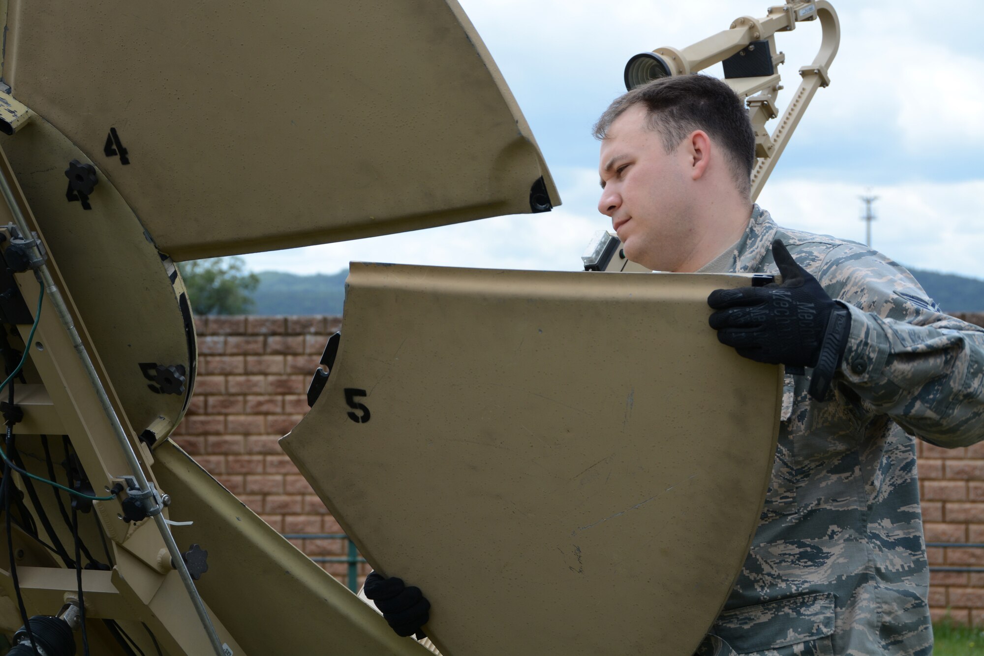 Tech. Sgt. Daniel Johnson, 433th Contingency Response Flight communications specialist, attaches a panel to a Small Package Initial Communications Equipment unit during preparation for exercise Swift Response, June 8, 2019, at Ramstein Air Base, Germany.