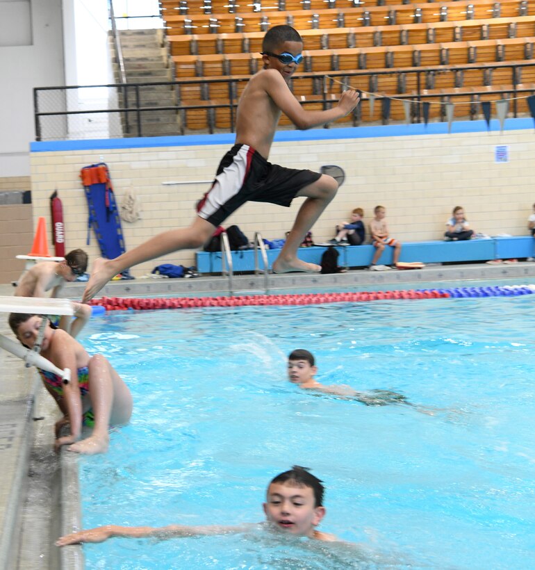 Children swim at the Summer Splash event at Ellsworth Air Force Base, S.D., July 1, 2019. The 28th Force Support Squadron hosted a pool party at the Bellamy Fitness Center where participants were able to escape the heat with a dip in the pool. (U.S. Air Force photo by Senior Airman Thomas Karol)