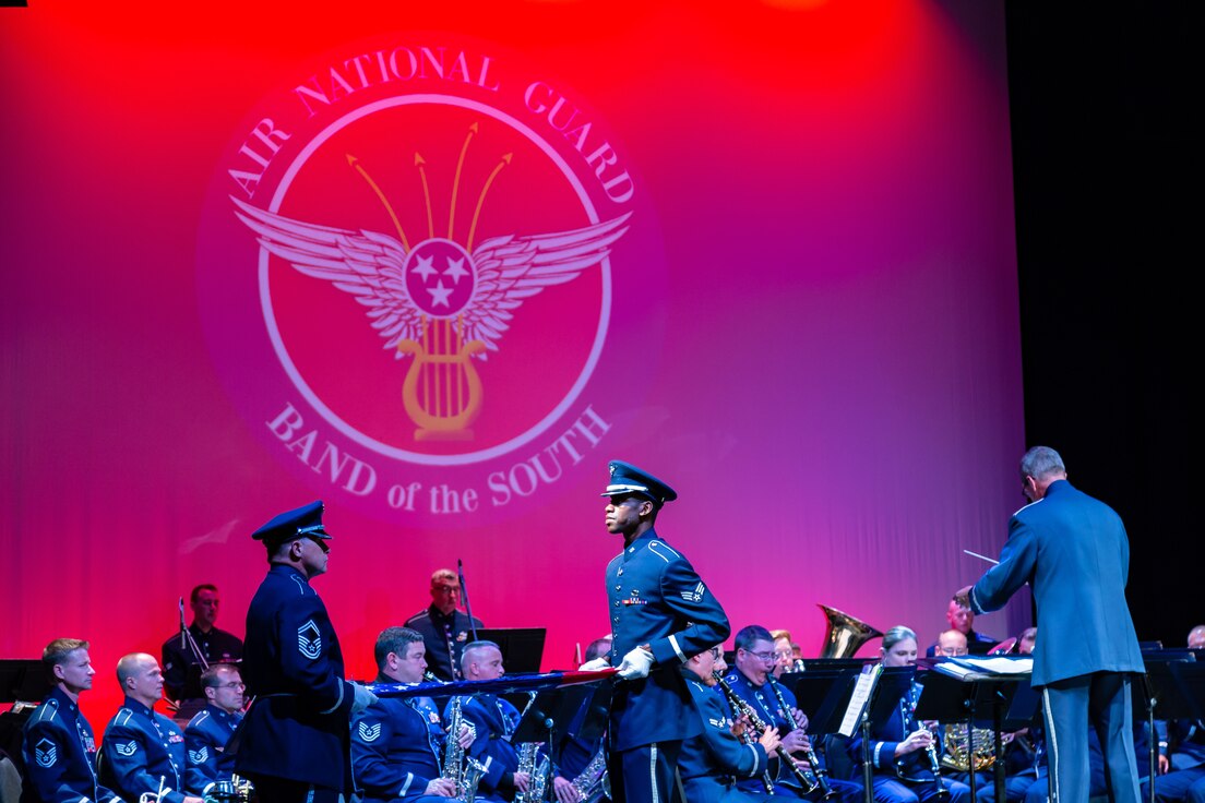 Master Sergeant Steve Burdick and Senior Airman Tony Watson fold our nation's flag during a performance by the concert band.