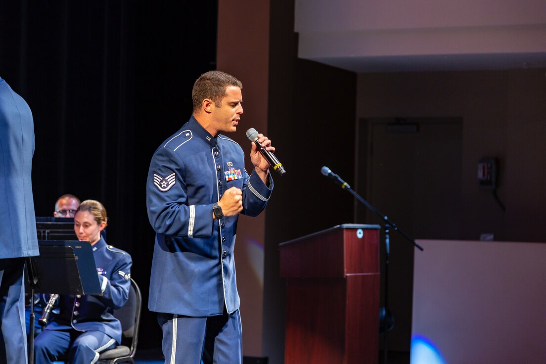 Staff Sergeant Evan Headrick and the concert band inspire the audience with Lee Greenwood's "God Bless the USA."