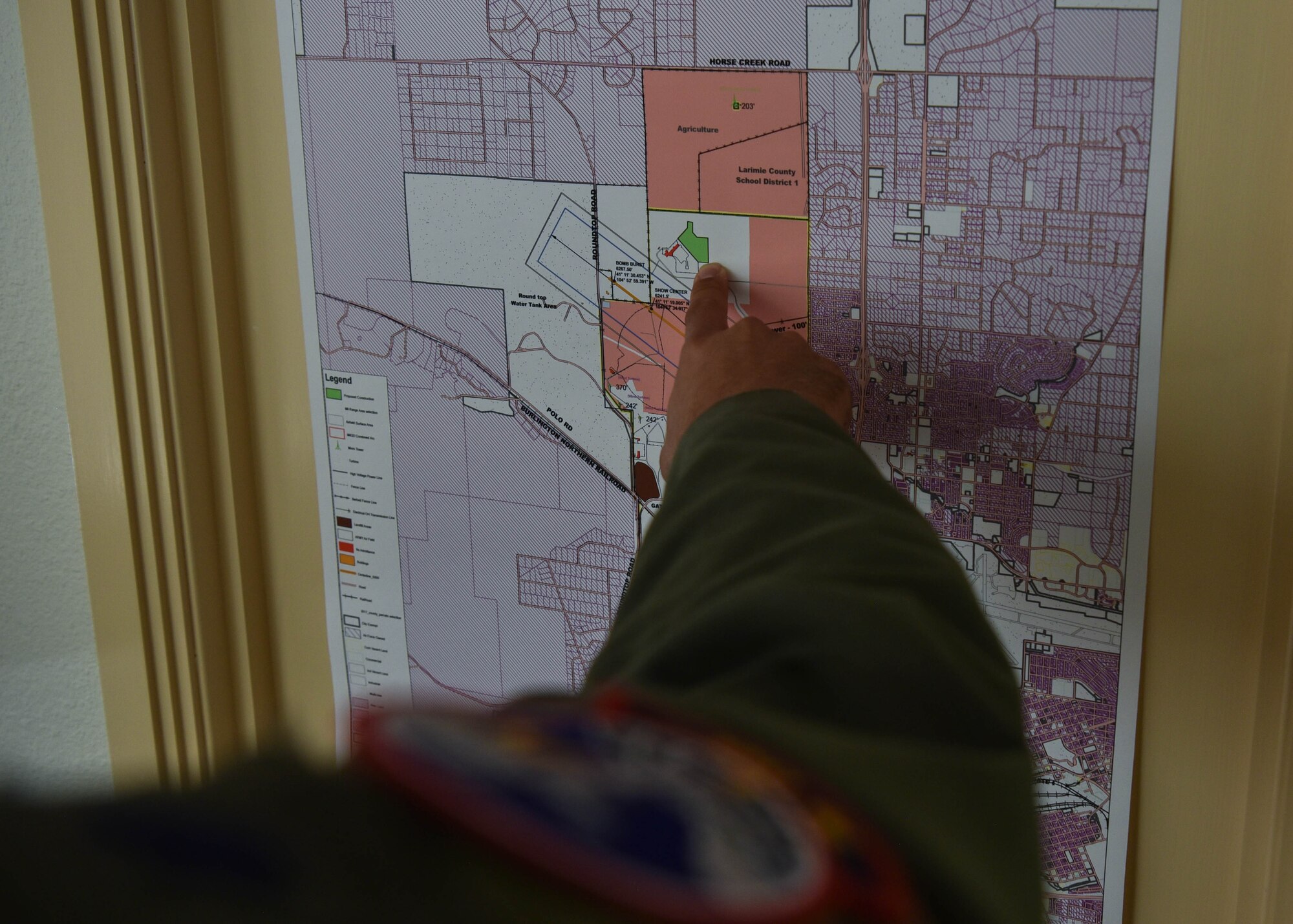 Lieutenant Colonel Christopher Picinni, 90th Operation Support Squadron director of operations, points to the location of the 2019 U.S. Air Force Thunderbirds air show viewing area, July 2, 2019, on F.E. Warren Air Force Base, Wyo. This marks the first time in 25 years that the Thunderbirds will fly over the skies of F.E. Warren.