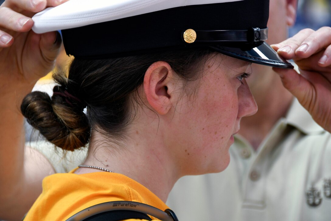 A Navy ROTC midshipman tries on a cover.