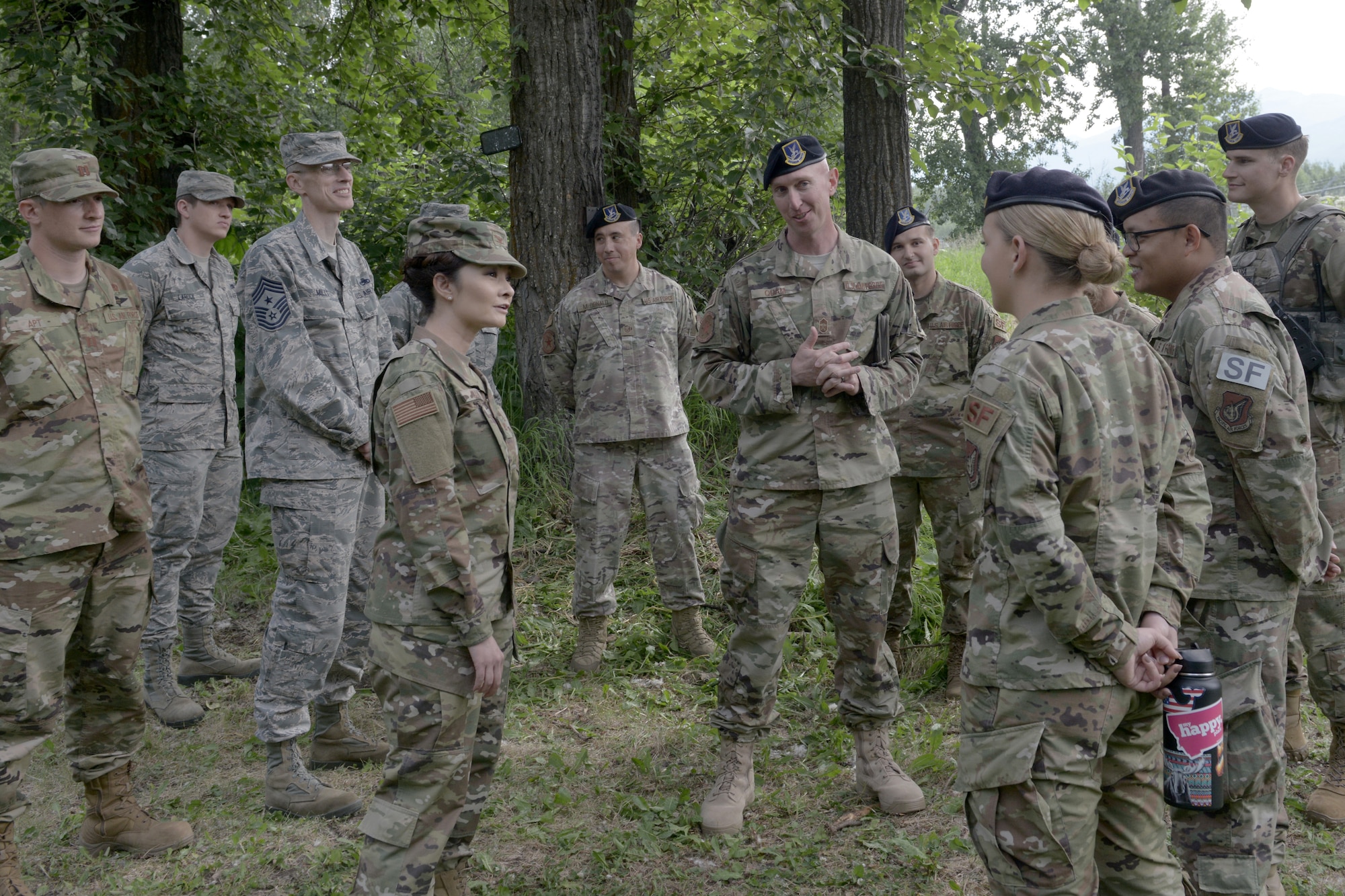 U.S. Air Force Col. Patricia Csànk, Joint Base Elmendorf-Richardson and 673d Air Base Wing commander, and Chief Master Sgt. Bradley Quam, a 673d Security Forces Squadron security forces manager, talk to security forces during a high-definition, two-way camera unveiling near a wildlife access point on Joint Base Elmendorf-Richardson, Alaska, July, 2, 2019. The unveiling of the cameras was a result of an MD5 workshop focused on the commander’s priority of improving gate security and efficiency. The cameras were installed to prevent unauthorized entry onto the installation. (U.S. Air Force photo by Airman 1st Class Emily Farnsworth)