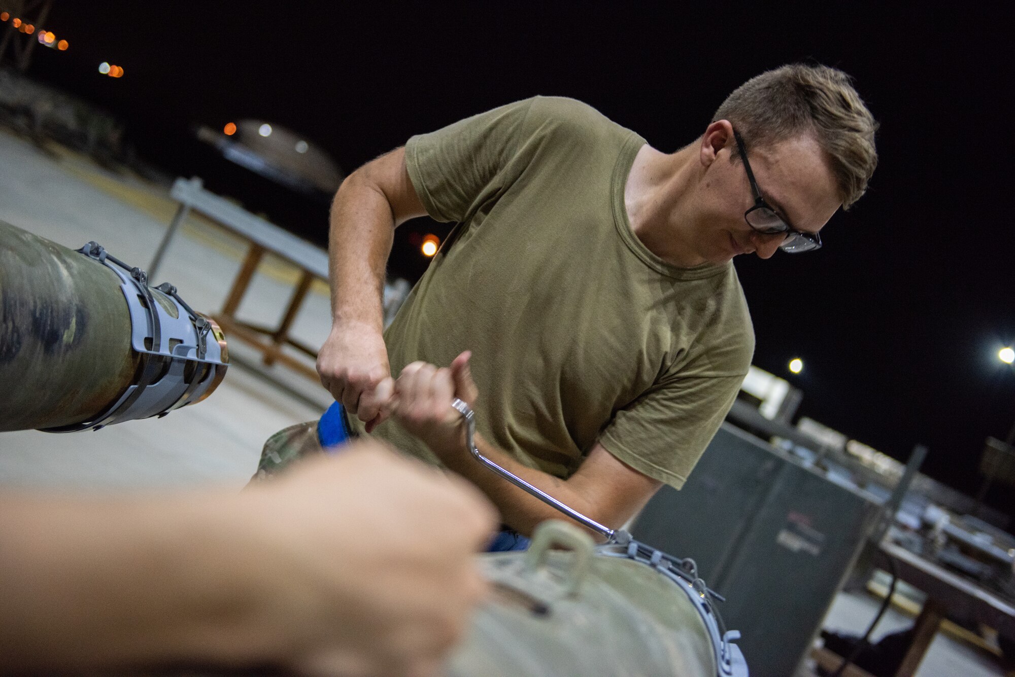 Staff Sgt. Kyle Poston, 380th Expeditionary Maintenance Squadron conventional maintenance crew chief, secures a strake to the front of a GBU-38 June 21, 2019, at Al Dhafra Air Base, United Arab Emirates.