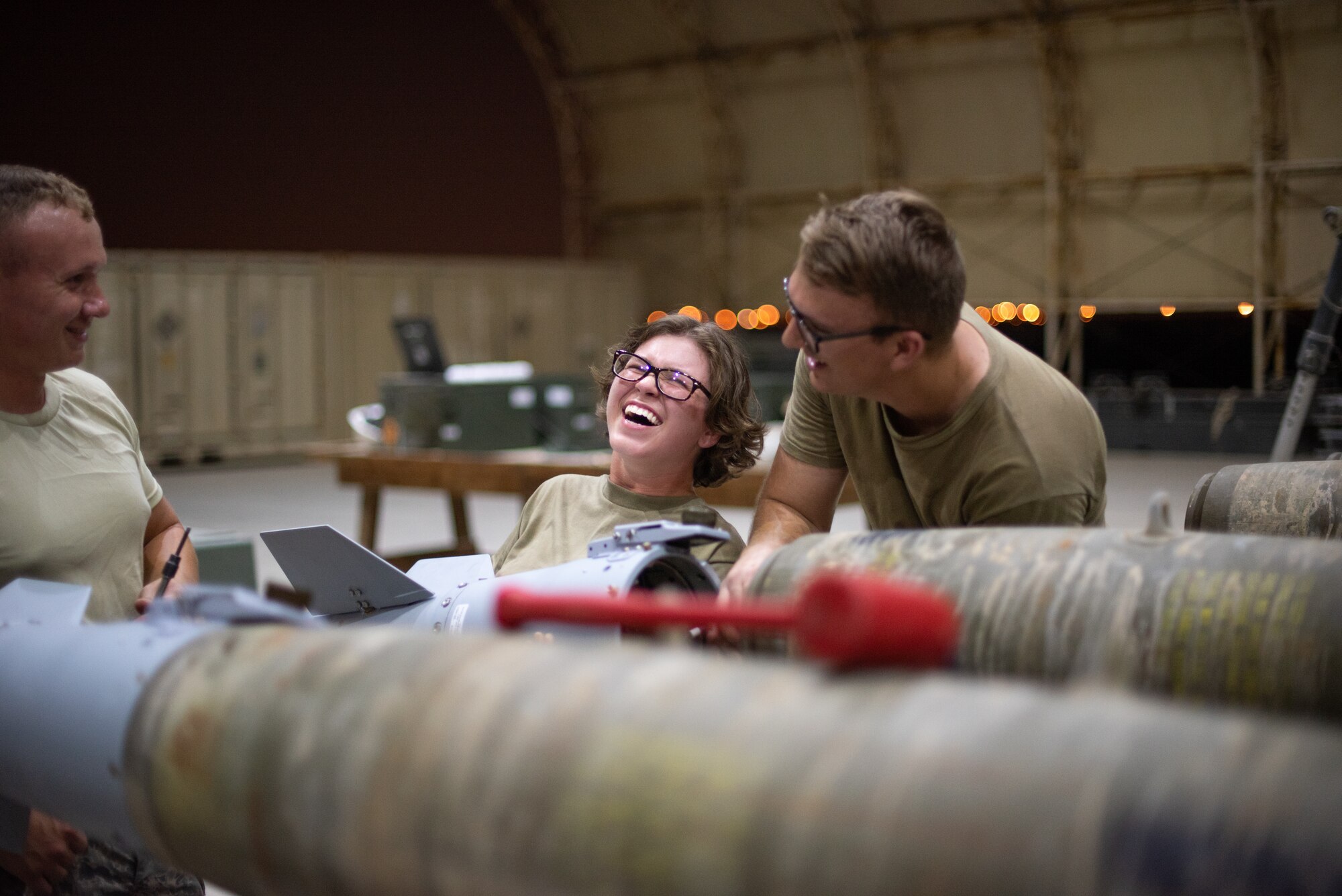 Airmen of 380th Expeditionary Maintenance Squadron attach a tail fin to a GBU-38 June 21, 2019, at Al Dhafra Air Base, United Arab Emirates.