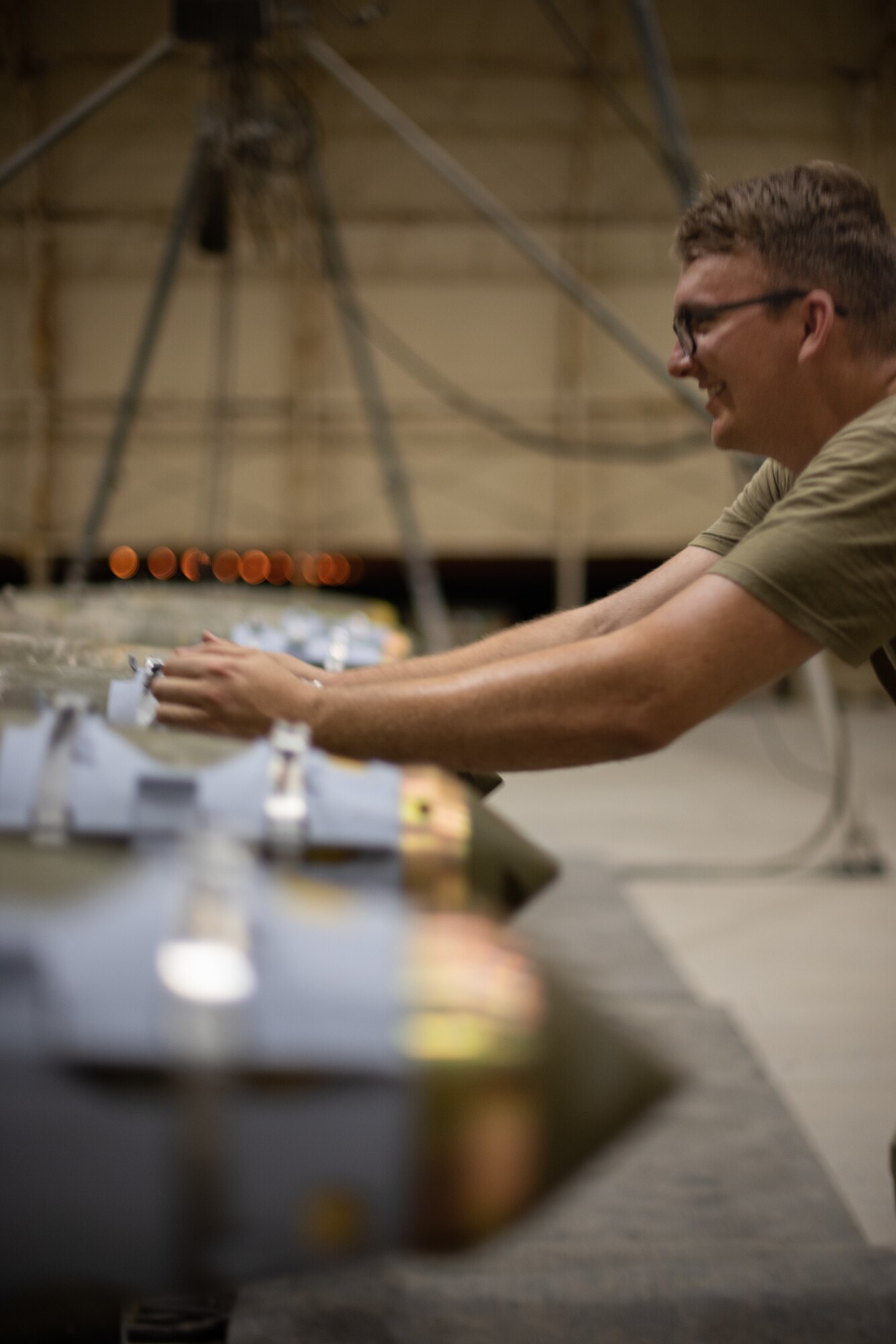 Staff Sgt. Kyle Poston, 380th Expeditionary Maintenance Squadron conventional maintenance crew chief, checks the alignment of a GBU-38 strake June 21, 2019, at Al Dhafra Air Base, United Arab Emirates.