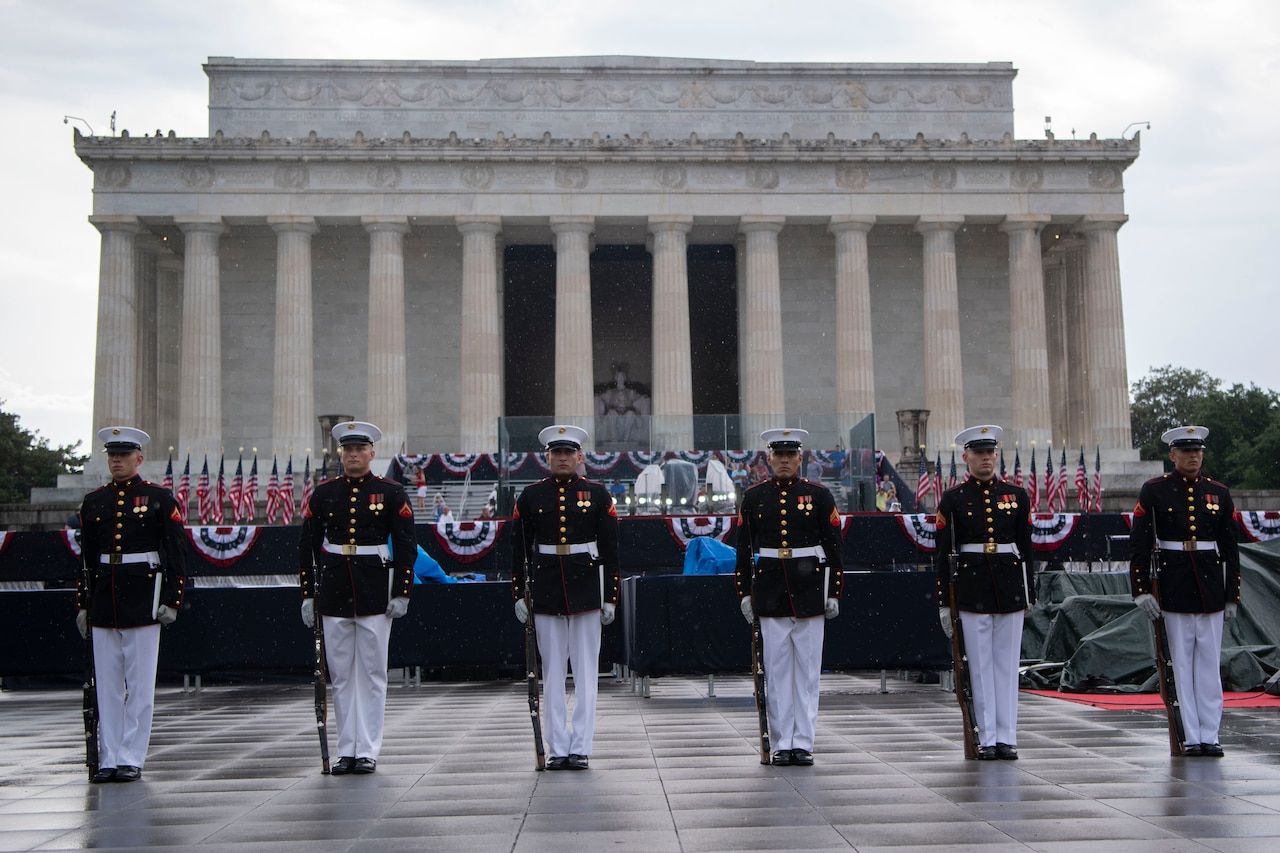Members of the Marine Corps Silent Drill Platoon stand in front of the Lincoln Memorial.