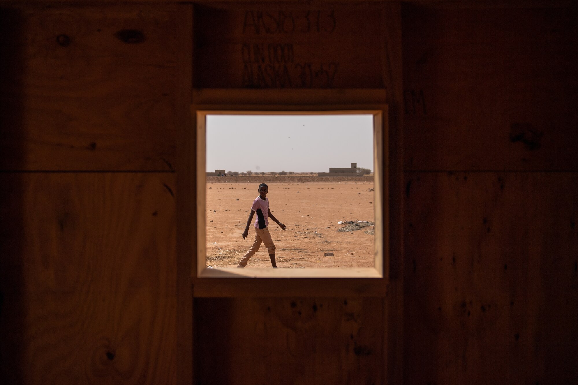 A Nigerien boy observes the recent construction on a classroom built by 724th Expeditionary Air Base Squadron civil engineer flight Airmen at a village in Agadez, Niger, June 27, 2019. The village’s previous classrooms were made of wooden sticks with a thatched roof. (U.S. Air Force photo by Staff Sgt. Devin Boyer)