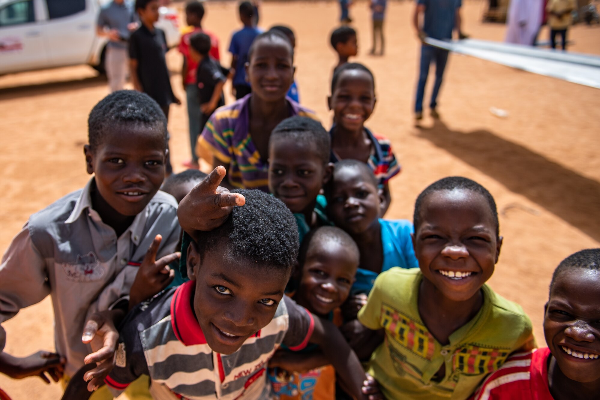 Nigerien children gather around for a photo at a village in Agadez, Niger, June 27, 2019. The 724th Expeditionary Air Base Squadron civil engineer flight built a new classroom for the village so they can learn in a more stable structure. (U.S. Air Force photo by Staff Sgt. Devin Boyer)