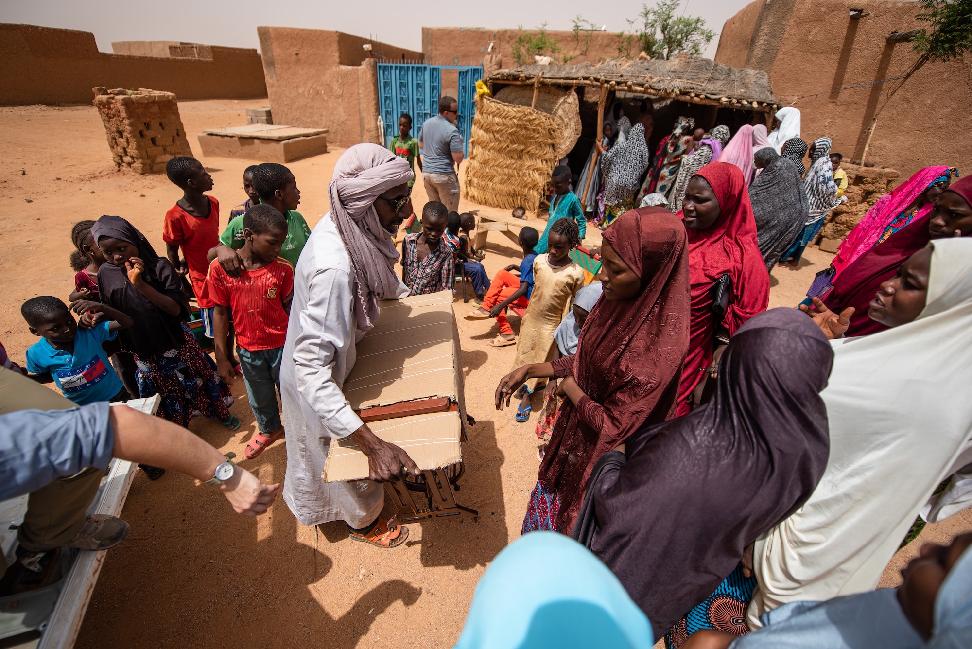 Nigerien women accept a donation of sewing supplies from Nigerien Air Base 201’s Women’s Association in Agadez, Niger, June 27, 2019. The village uses the sewing equipment to make a variety of products they sell, so they can provide for their families. (U.S. Air Force photo by Staff Sgt. Devin Boyer)