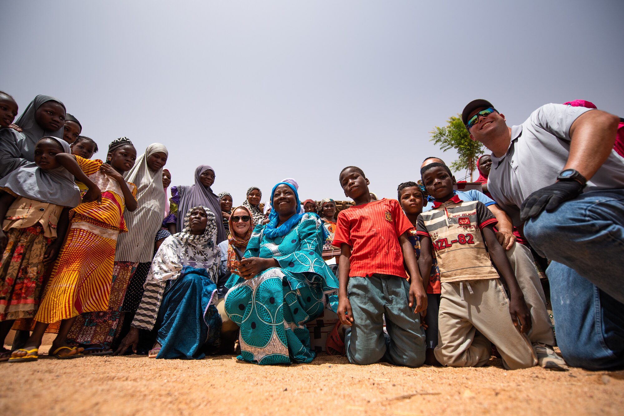 Nigeriens, and Nigerien Air Base 201 personnel pose for a photo at a village in Agadez, Niger, June 27, 2019. The women’s association from the base donated sewing supplies to the village. (U.S. Air Force photo by Staff Sgt. Devin Boyer)