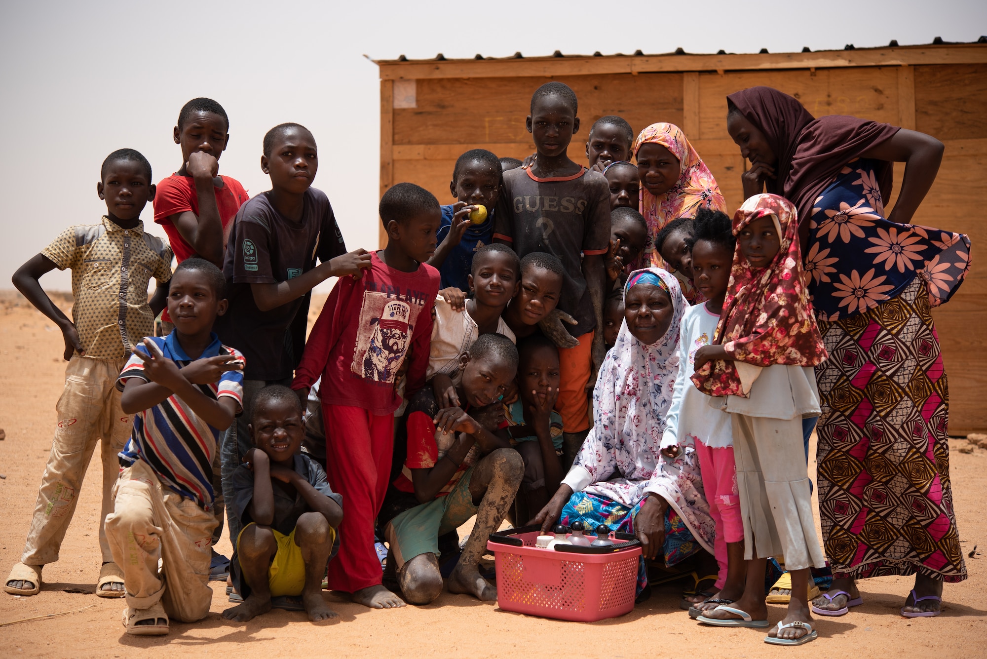 Nigeriens pose for a photo in front of a classroom at a village in Agadez, Niger, June 27, 2019. The 724th Expeditionary Air Base Squadron civil engineer flight built the classroom for the village. (U.S. Air Force photo by Staff Sgt. Devin Boyer)