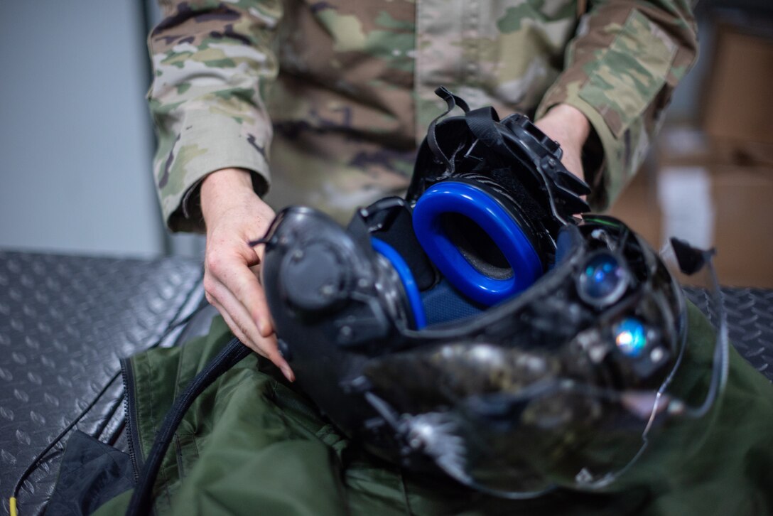 Airman 1st Class Ryan Joplin, 380th Expeditionary Operations Support Squadron aircrew flight equipment technician, inspects an F-35A Lightning pilot helmet June 26, 2019, at Al Dhafra Air Base, United Arab Emirates.