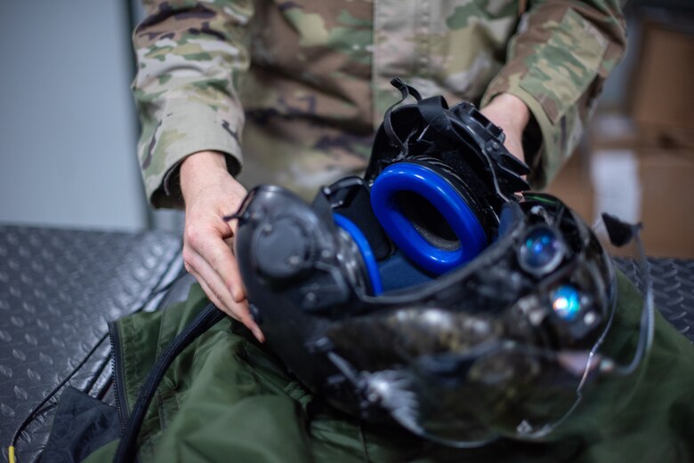 Airman 1st Class Ryan Joplin, 380th Expeditionary Operations Support Squadron aircrew flight equipment technician, inspects an F-35A Lightning pilot helmet June 26, 2019, at Al Dhafra Air Base, United Arab Emirates.