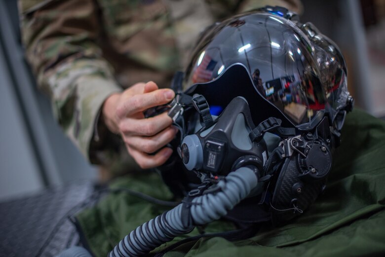 Airman 1st Class Ryan Joplin, 380th Expeditionary Operations Support Squadron aircrew flight equipment technician, inspects an F-35A Lightning pilot helmet June 26, 2019, at Al Dhafra Air Base, United Arab Emirates.