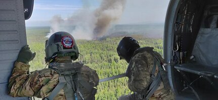 Two Alaska Army National Guard UH-60 Black Hawk helicopters and aircrew from 1st Battalion, 297th Aviation perform Bambi bucket water drops over the Montana Creek Fire, July 4, 2019.