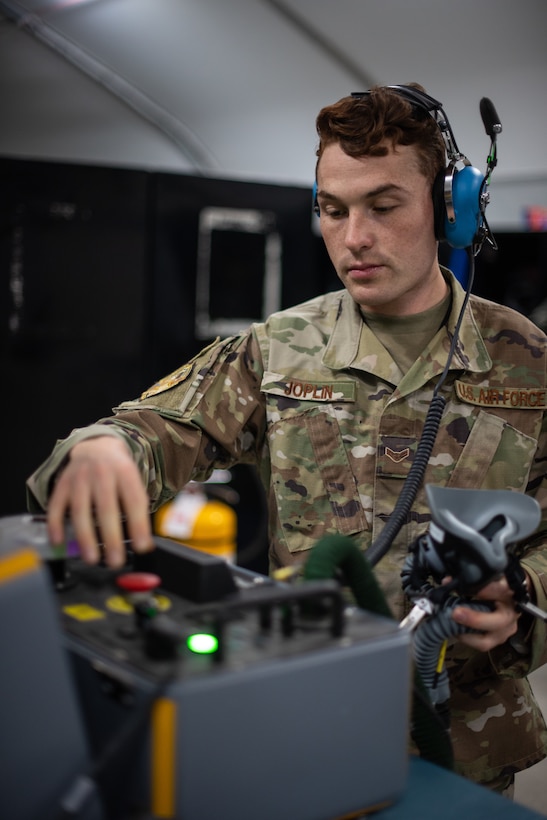 Airman 1st Class Ryan Joplin, 380th Expeditionary Operations Support Squadron aircrew flight equipment technician, checks an oxygen mask for an F-35A Lightning helmet June 26, 2019, at Al Dhafra Air Base, United Arab Emirates.