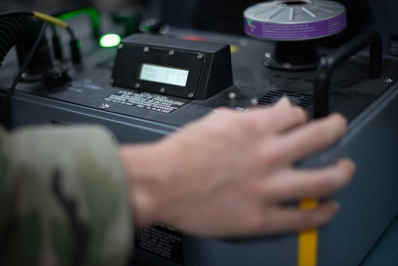 Airman 1st Class Ryan Joplin, 380th Expeditionary Operations Support Squadron aircrew flight equipment technician, checks an oxygen mask for an F-35A Lightning helmet June 26, 2019, at Al Dhafra Air Base, United Arab Emirates.