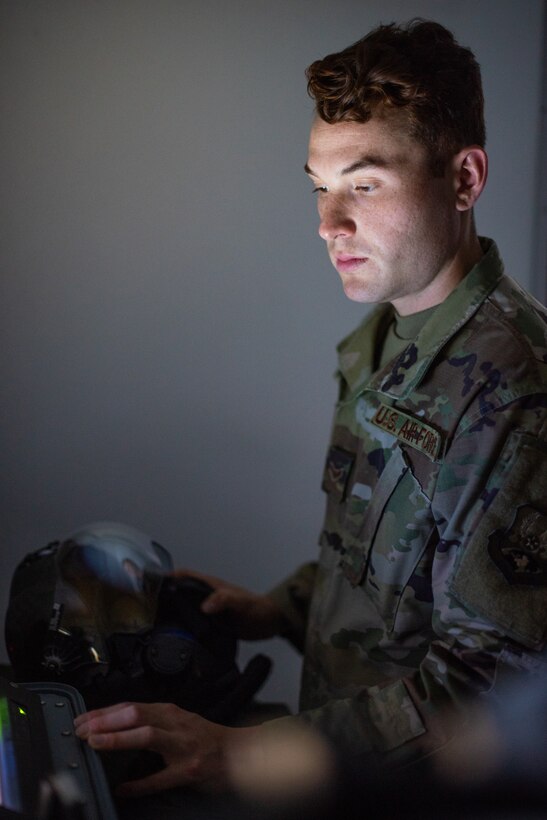Airman 1st Class Ryan Joplin, 380th Expeditionary Operations Support Squadron aircrew flight equipment technician, checks an F-35A Lightning helmet and its vehicle interface June 26, 2019, at Al Dhafra Air Base, United Arab Emirates.