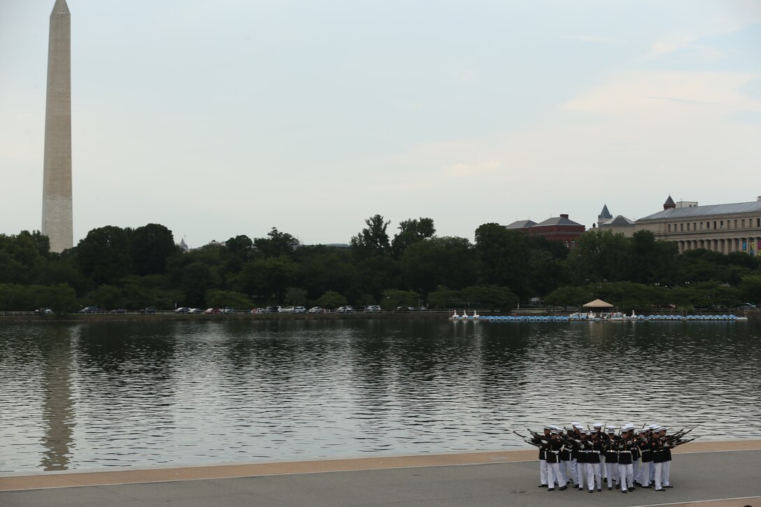 Marines with the U.S. Marine Corps Silent Drill Platoon execute “bursting bomb” during a Tuesday Sunset Parade at the Thomas Jefferson Memorial, Washington, D.C., July 2, 2019. The hosting official for the evening was Brigadier Gen. Lorna Mahlock, director, Command, Control, Communications and Computers, and the guest of honor was Ms. Sheila Casey, chief operating officer for the Hill and Chair of the Board of Directors for Blue Star Families. (U.S. Marine Corps photo by Sgt. Robert Knapp/Released)