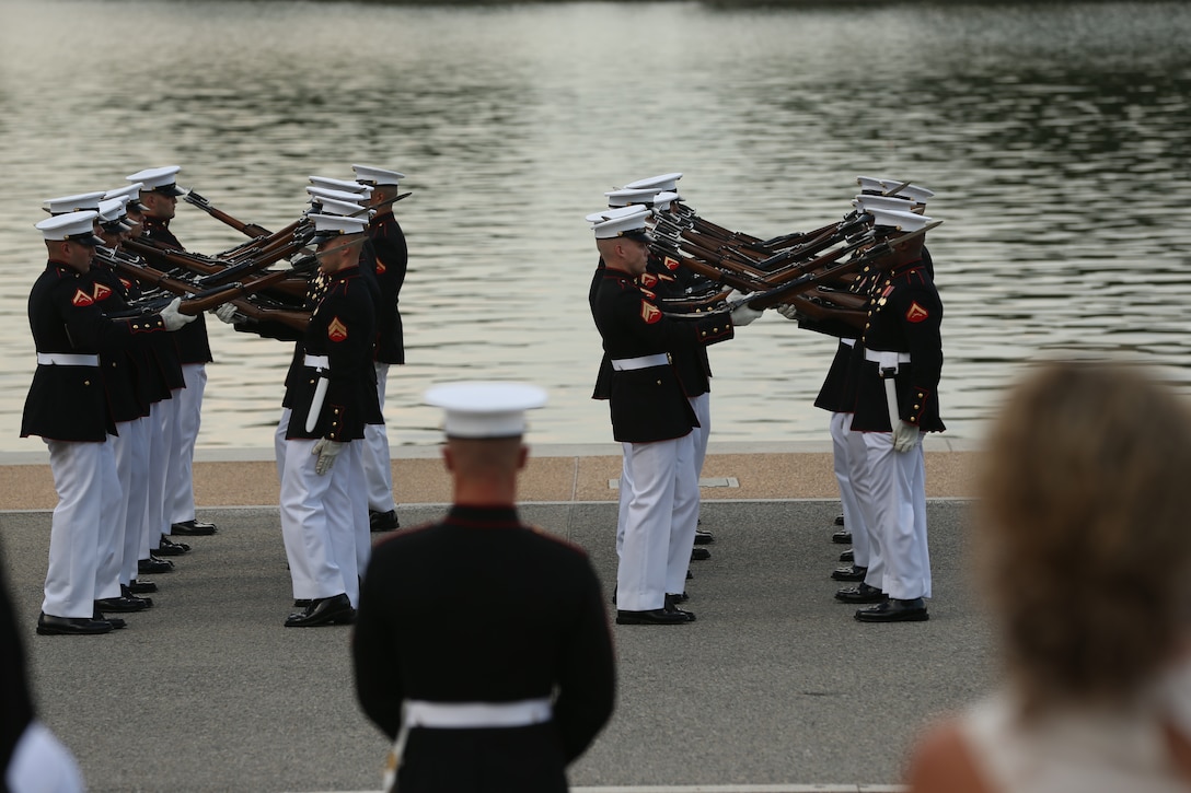 Marines with the U.S. Marine Corps Silent Drill Platoon execute precision drill movements during a Tuesday Sunset Parade at the Thomas Jefferson Memorial, Washington, D.C., July 2, 2019. The hosting official for the evening was Brigadier Gen. Lorna Mahlock, director, Command, Control, Communications and Computers, and the guest of honor was Ms. Sheila Casey, chief operating officer for the Hill and Chair of the Board of Directors for Blue Star Families. (U.S. Marine Corps photo by Sgt. Robert Knapp/Released)